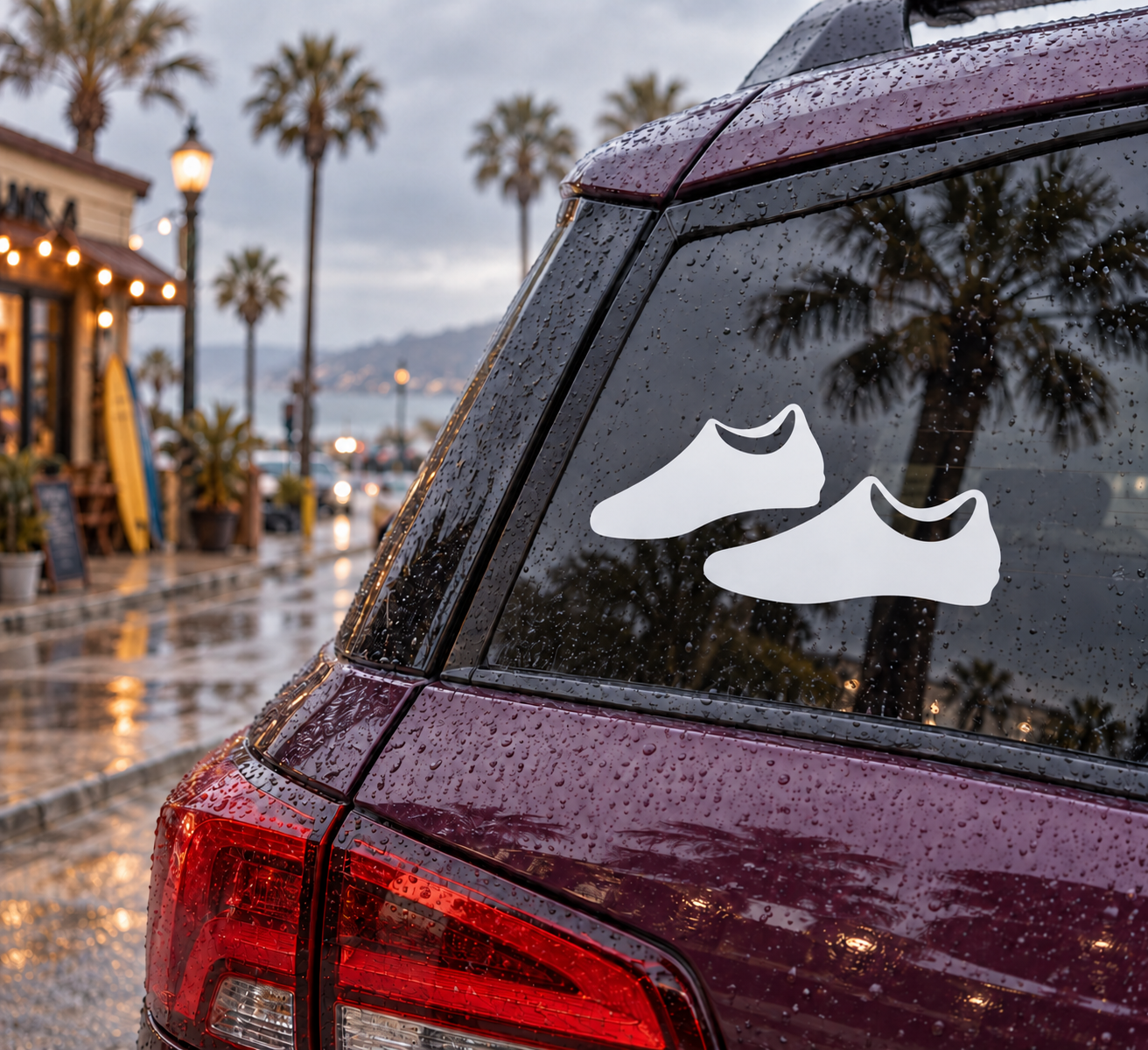 Pair of cleat vinyl decals with two white shoe icons on a car window