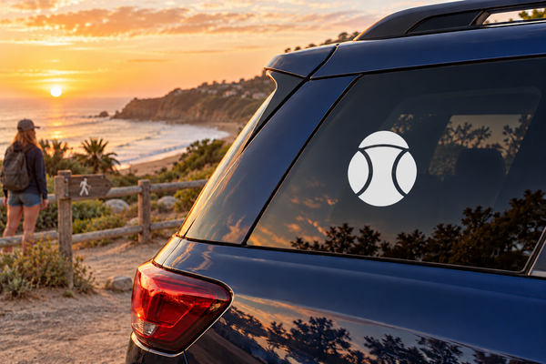Softball logo vinyl decal with white ball icon on a car rear window