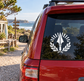Vinyl decal with white Spartan spear and sunburst, plus laurel wreath on car window