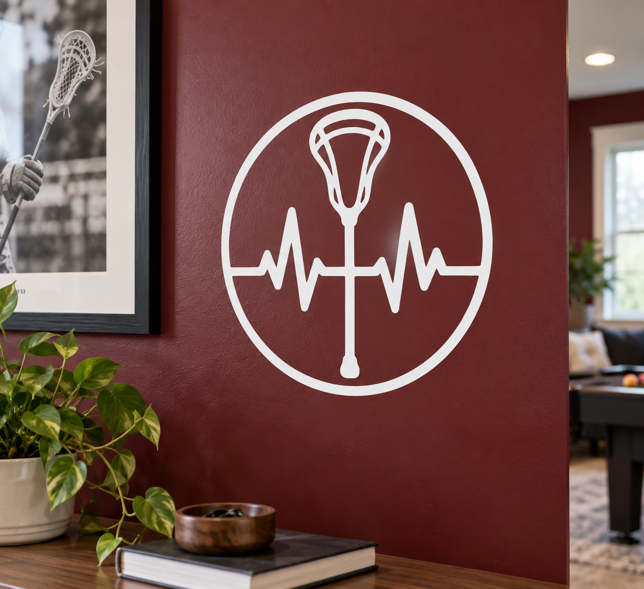Vinyl lacrosse badge decal with white trophy and heartbeat line on dark red surface
