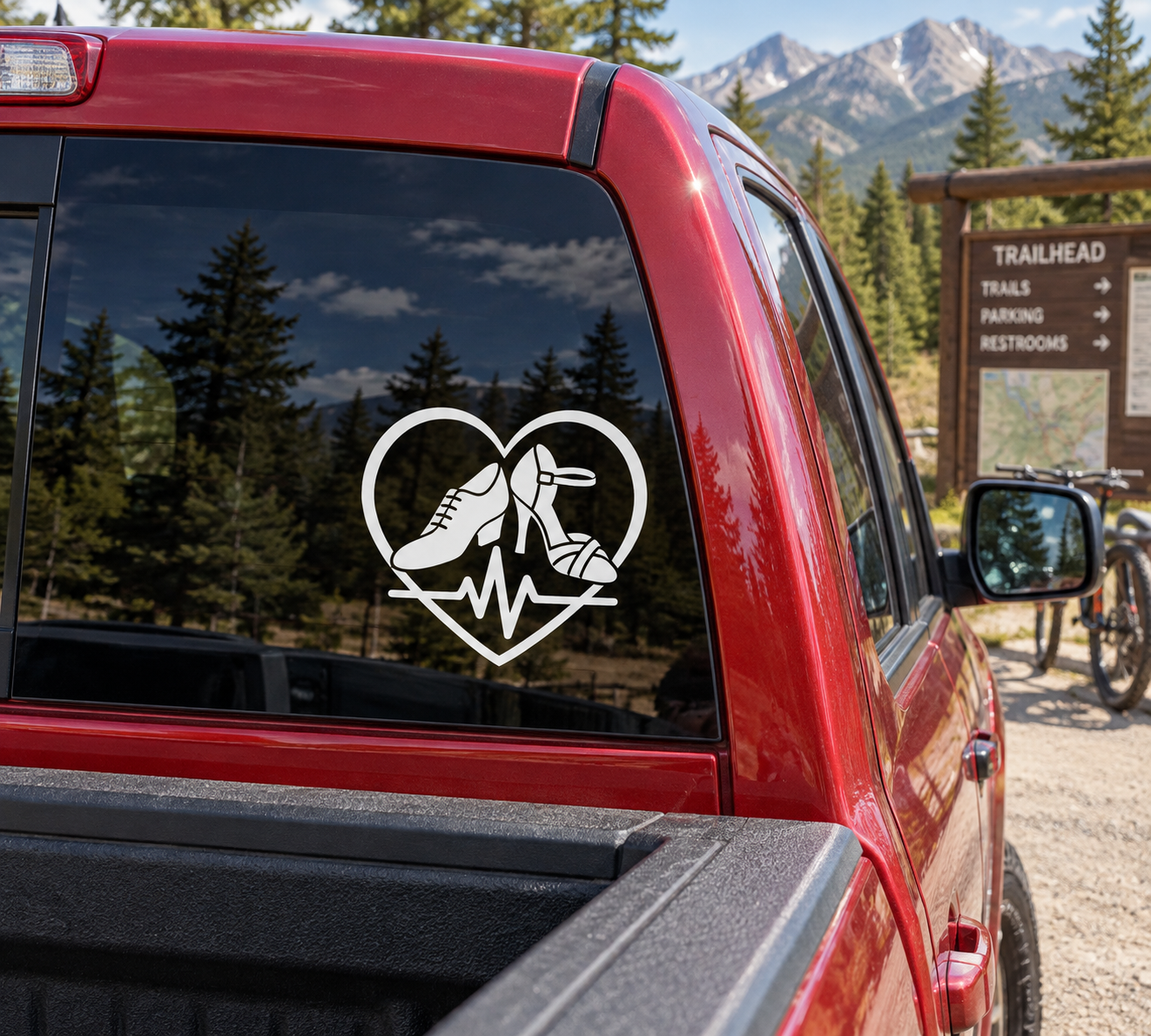 Red vehicle window with heart-shaped vinyl decal showing dancing shoes and heartbeat line