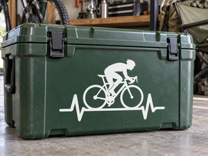 White vinyl decal of a cyclist silhouette with heartbeat line on a dark green surface