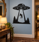 UFO vinyl decal: black saucer with beam, alien silhouette, and pine trees