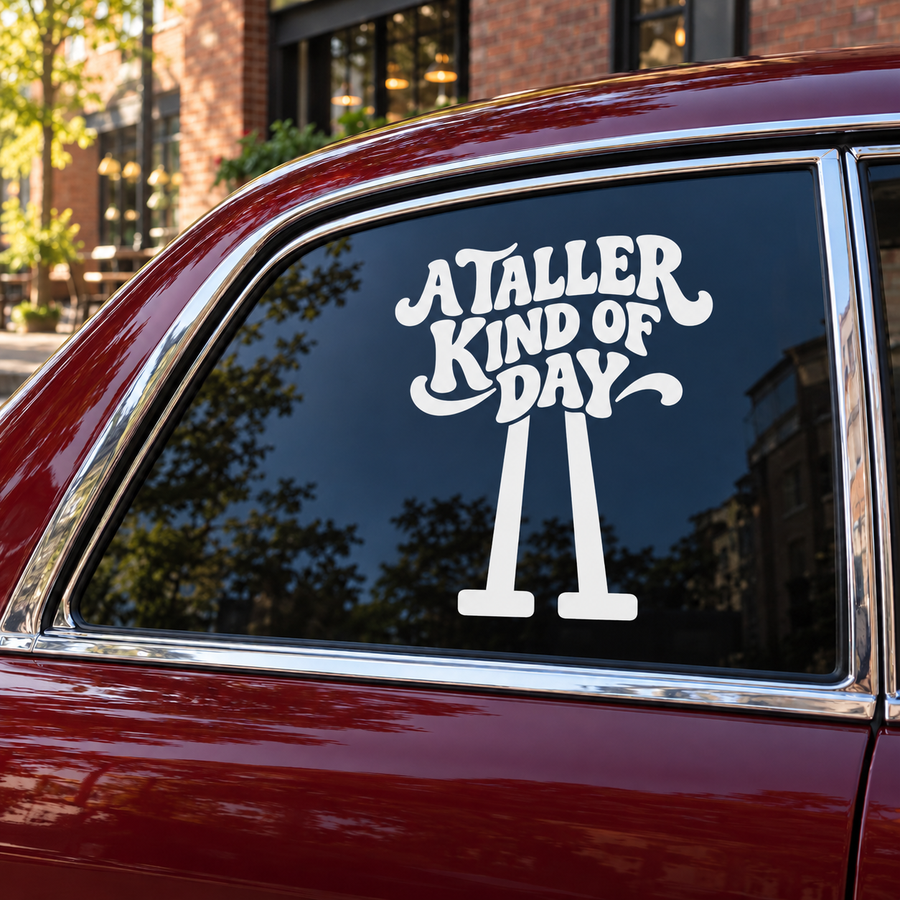 Vinyl window decal with 'A Taller Kind of Day' text and stilt icon