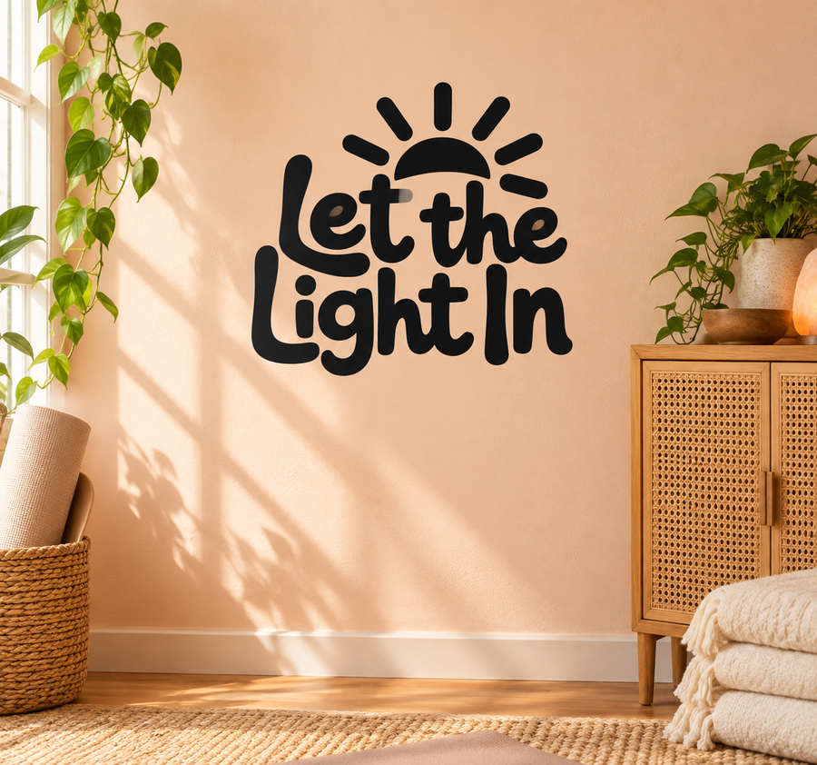 Black vinyl wall decal with “Let the Light In” text and sunburst icon