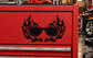 Vinyl decal of black flaming sunglasses on red surface