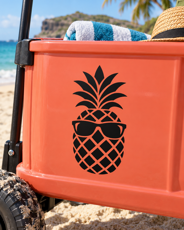 Pineapple with sunglasses vinyl decal in black on an orange surface