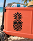 Pineapple with sunglasses vinyl decal in black on an orange surface