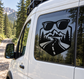 Sunglasses road-trip vinyl decal on a van window, with mountains, trees, and winding road