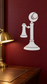White vinyl candlestick-style decorative decal with spherical top on wall