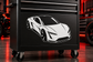 Stylized white sports car vinyl decal on dark background, side view