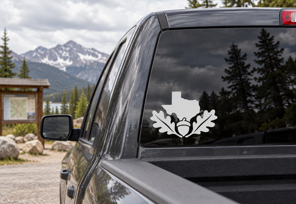 Texas oak and acorn vinyl decal on a car window: white Texas silhouette with leaf and acorn
