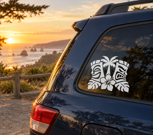 White tiki faces vinyl decal with hibiscus on dark car rear window