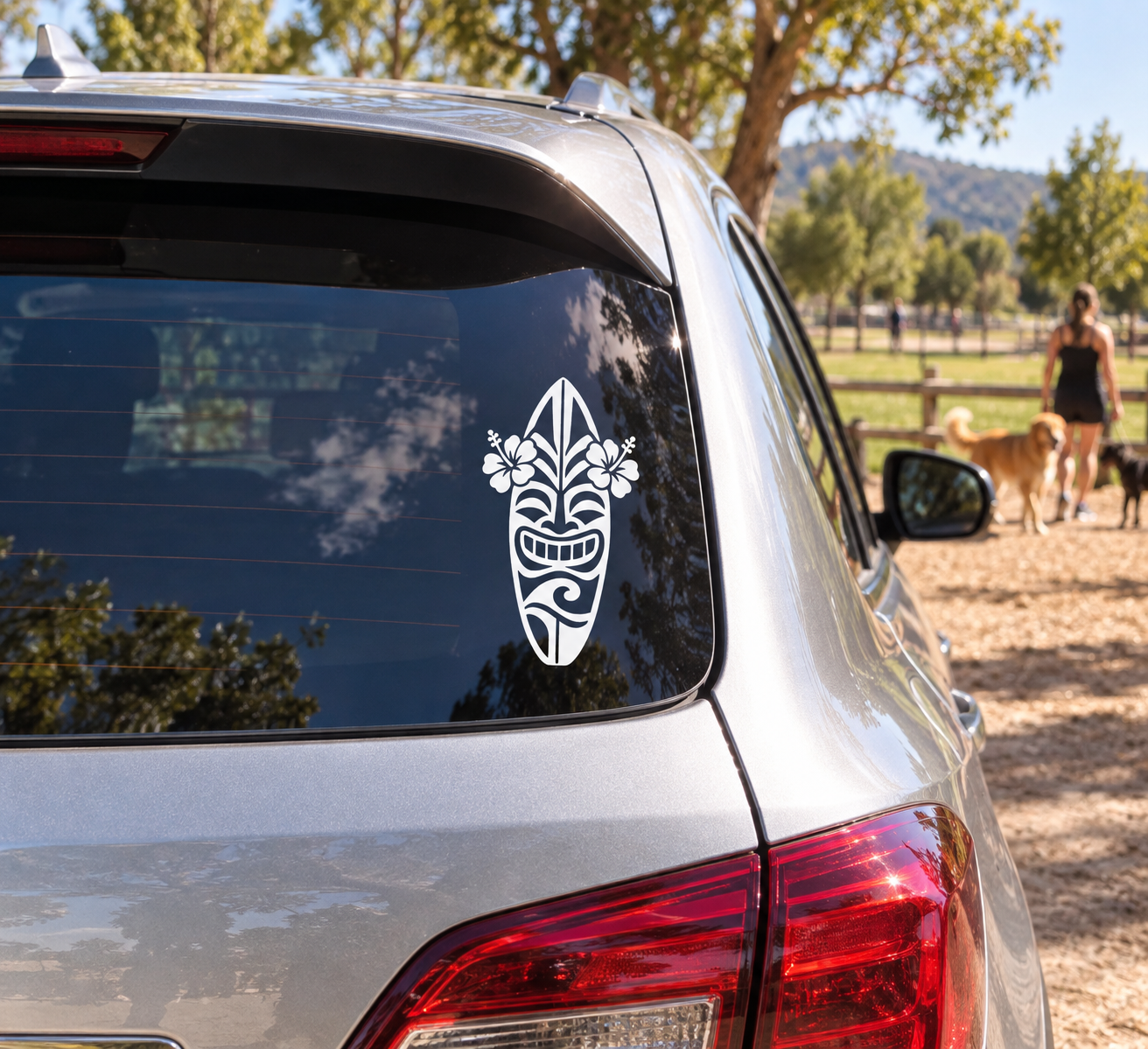 Surf tiki vinyl decal on car rear window, white tribal surfboard face with flowers