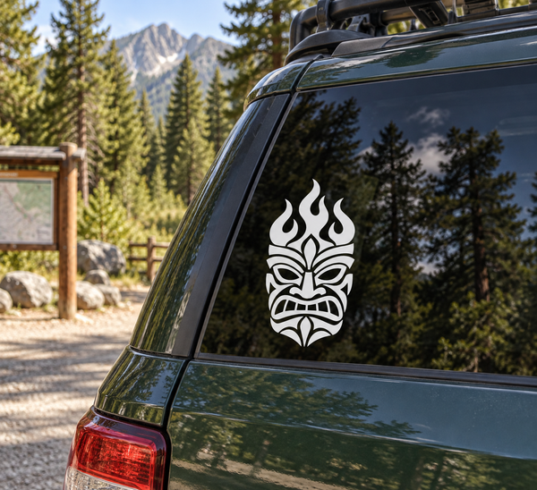 Flame tiki vinyl decal on a dark car window, white tiki head with flame details