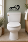 Black sleeping cat vinyl decal with curved question mark above a toilet