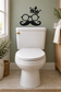 Toilet wall vinyl decal: black crown, round glasses, and curled mustache