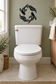 Black koi fish vinyl wall decal above toilet lid