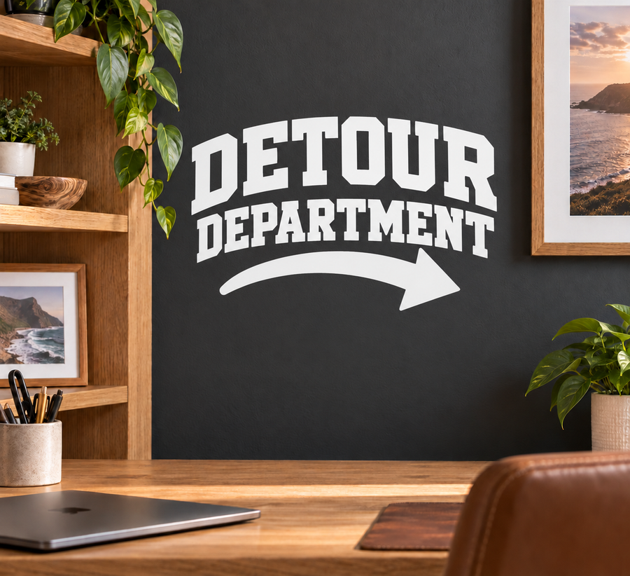 Vinyl decal with DETOUR DEPARTMENT lettering and curved arrow, white on dark surface