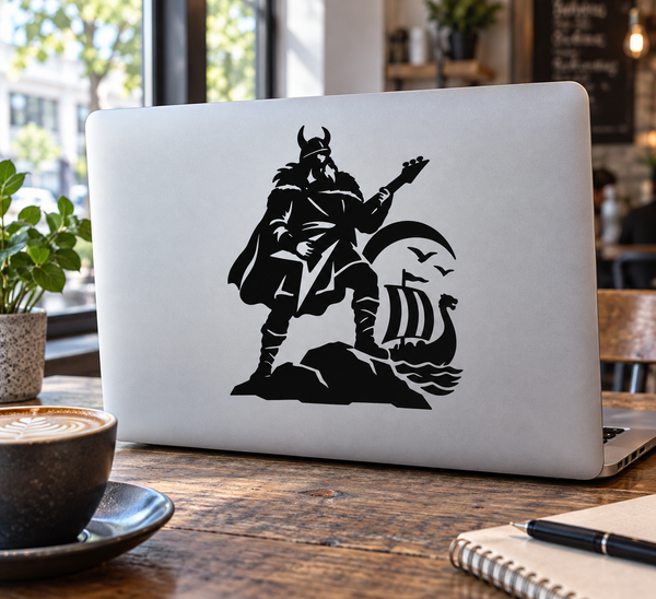 Viking guitarist vinyl decal showing black silhouette with guitar and shield on laptop