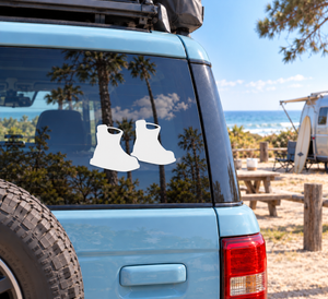 Wakeboarding boot binding vinyl decal pair on a car window, white boots