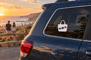 Vinyl wakeboarding tote decal on car rear window, white icon with black bag and wakeboard