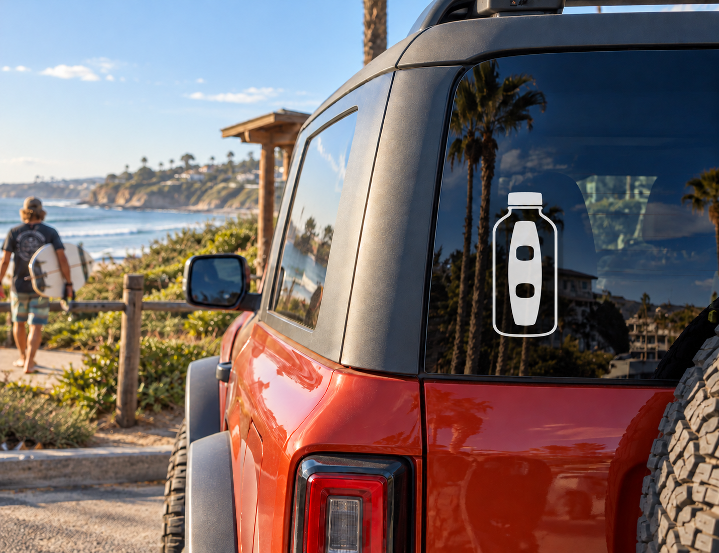 Bottle-shaped wakeboarding vinyl decal on car window, black and white