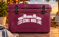 Purple vinyl decal on a cooler: LESS SCROLL MORE LAKE with two hat icons