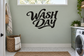Wash Day vinyl wall decal with black cursive lettering on a light wall