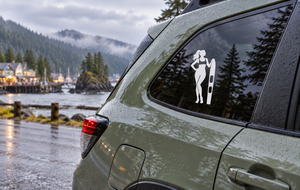 Water skiing vinyl decal with white skier silhouette on a car rear window