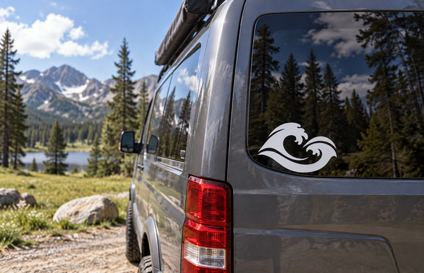 Vinyl decal on vehicle rear window, white and black wave swirl design