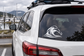 Car rear window vinyl decal: black storm-wave graphic on dark glass