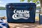 Vinyl decal: white Follow the Tide lettering with wave flourish on dark blue