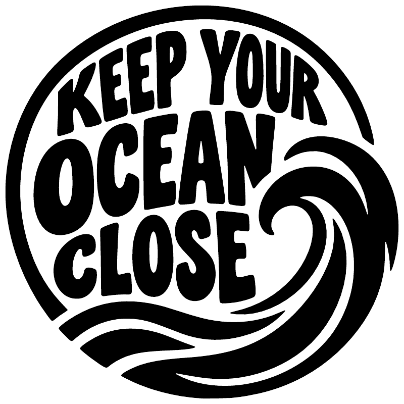 Close-up circular vinyl decal, black and white 'KEEP YOUR OCEAN CLOSE' with wave