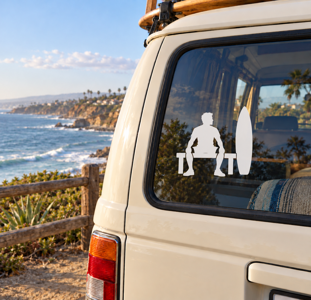 Surfer vinyl decal with kneeling figure, surfboard silhouette on car window