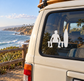 Surfer vinyl decal with kneeling figure, surfboard silhouette on car window