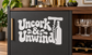 Vinyl decal with “Uncork & Unwind” lettering and wine bottle silhouette, white on dark.