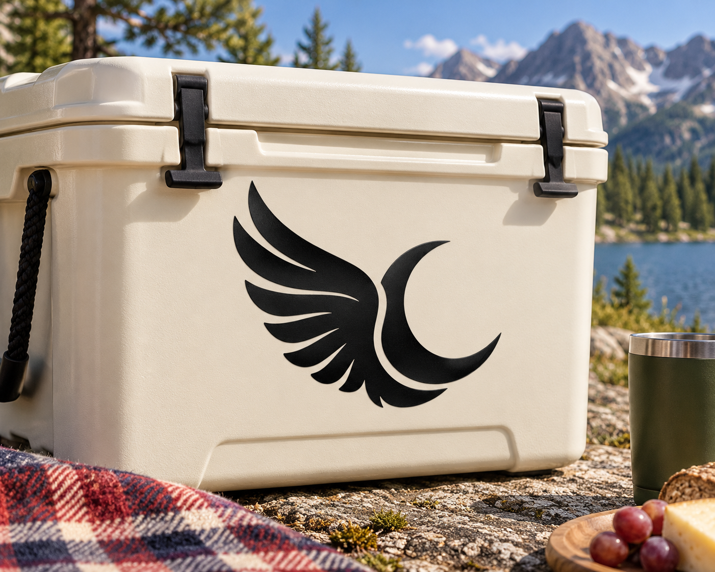Black wing and crescent moon vinyl decal on a light cooler lid