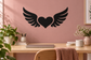 Black vinyl decal of a heart with symmetrical wing shapes on a wall