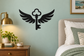 Black winged key vinyl wall decal with symmetrical feathered wings and key stem