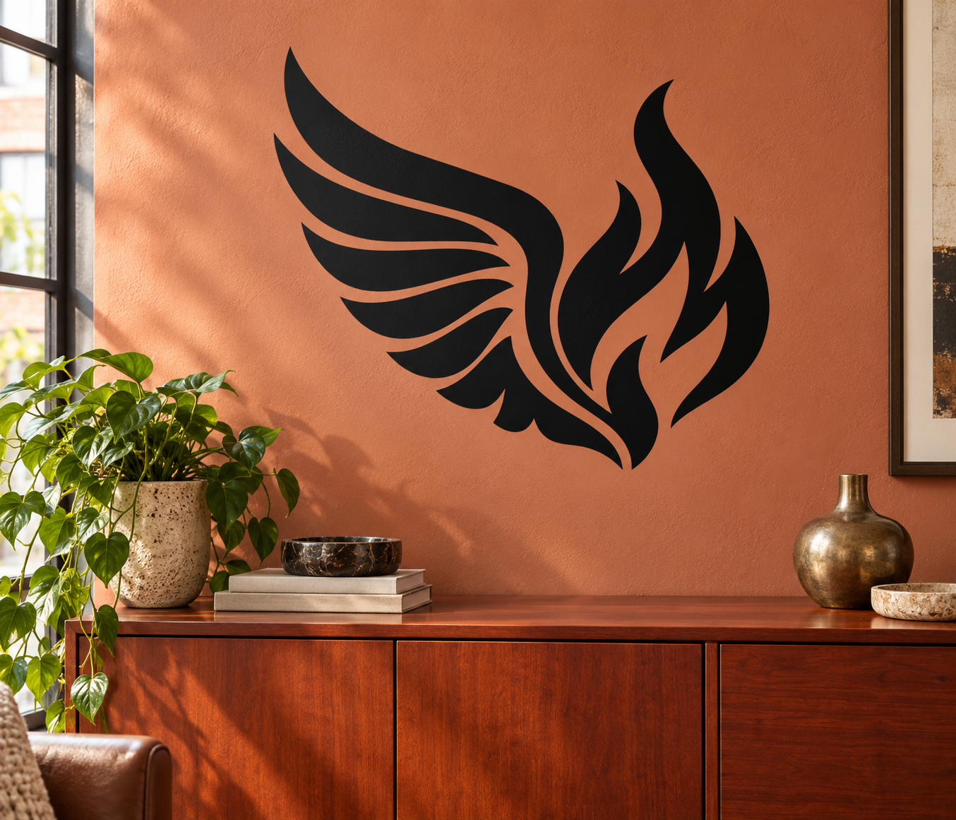 Black wing and flame vinyl decal graphic for walls, centered on the surface.