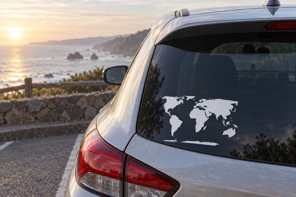 World map vinyl decal on car rear window, black continents and ocean outline