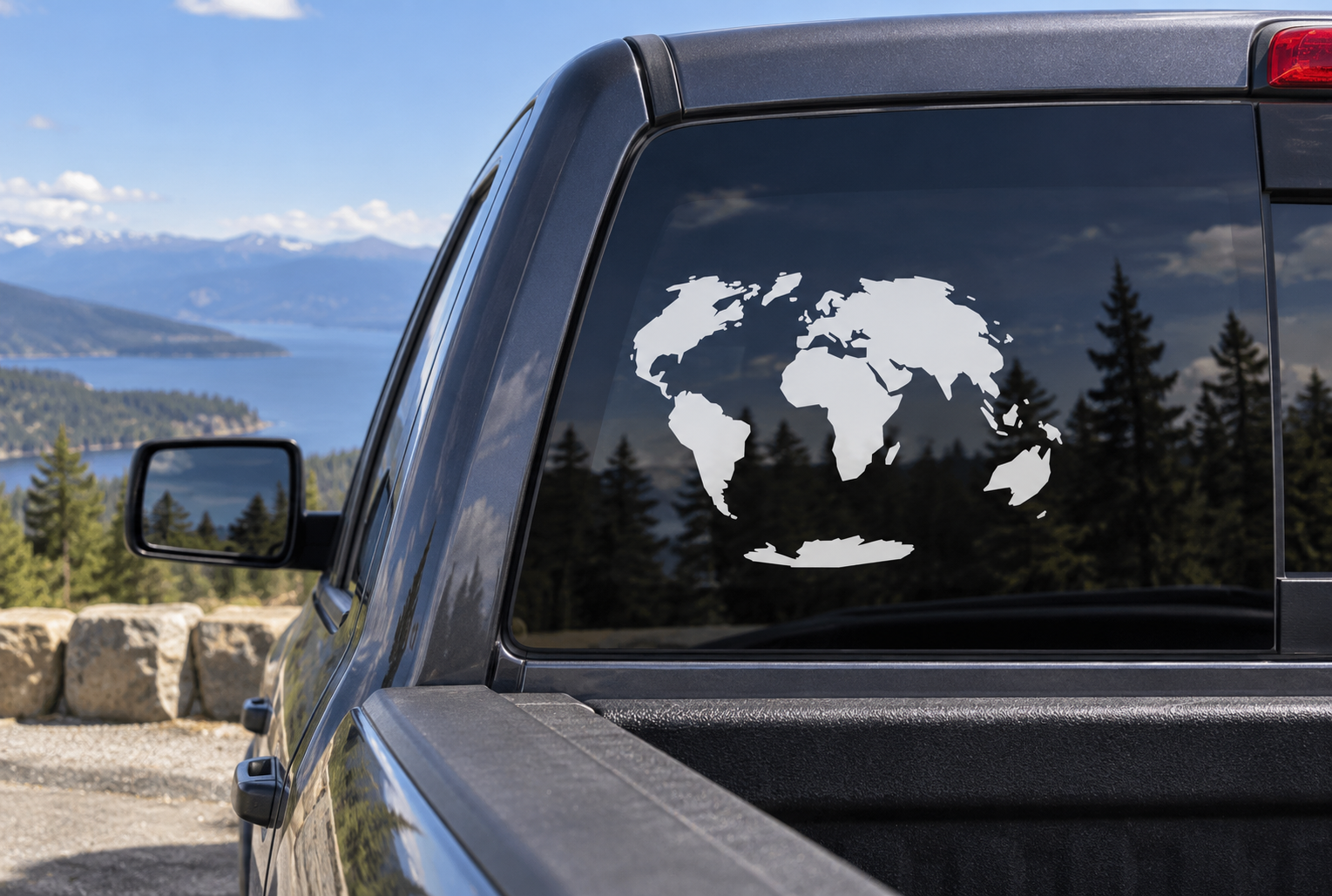 World map continents vinyl decal on car window, white continents against dark glass.