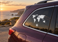 Vinyl world map decal on car window with white continents and sun icon