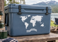 World map vinyl decal with three-line route arrow, white on dark surface