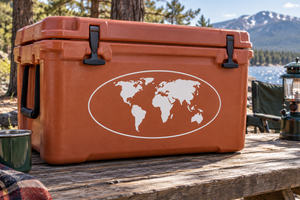 World map vinyl decal with white oval outline, shown on an orange cooler