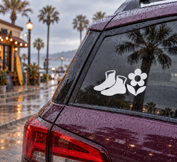 Wrestling shoes and wildflower vinyl decal on vehicle rear window