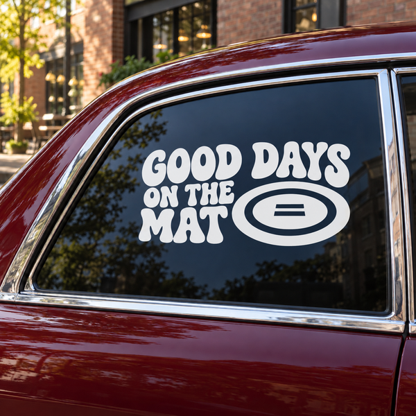 Vinyl wrestling decal with text 'GOOD DAYS ON THE MAT' and oval icon on car window