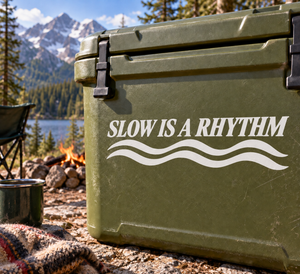 Green surface with vinyl decal text "SLOW IS A RHYTHM" and wavy lines