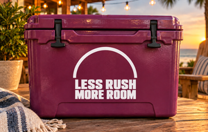 White vinyl decal reading “LESS RUSH MORE ROOM” with arched line on a burgundy cooler